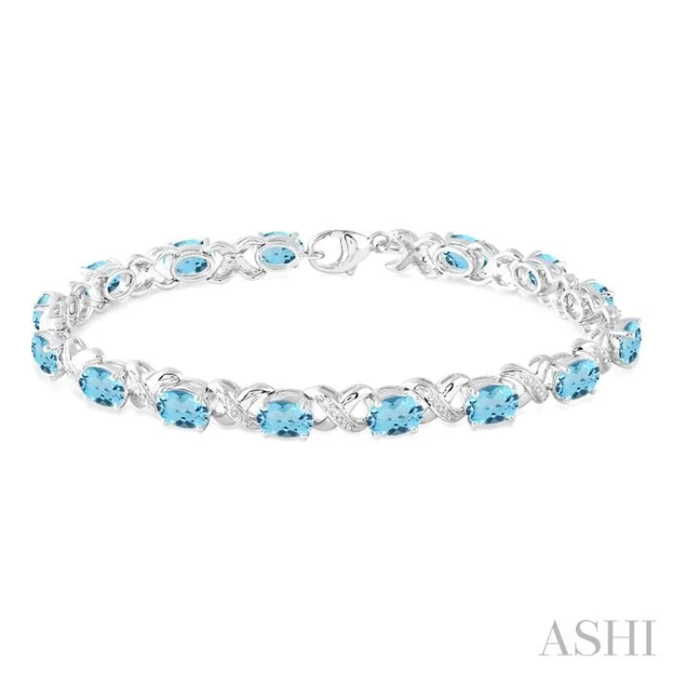 Birthstone Bracelets for Women-7x5 mm Oval Cut Blue Topaz and 1/20 Ctw Round Cut Diamond Fashion Bracelet in Sterling Silver